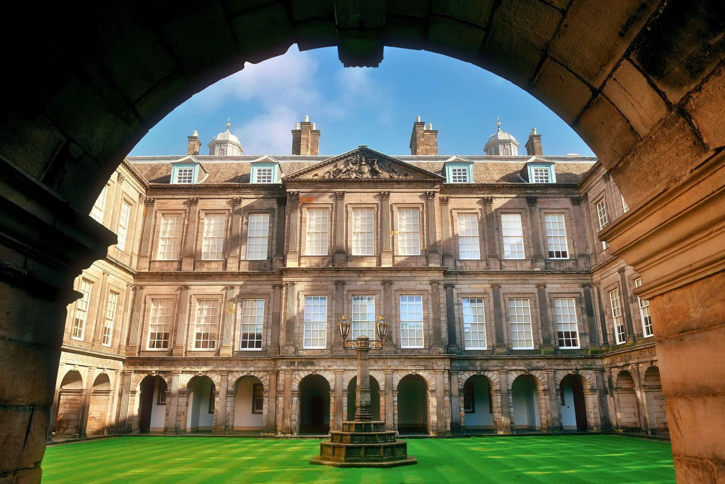 The front facade and courtyard of the Palace of Holyroodhouse in Edinburgh